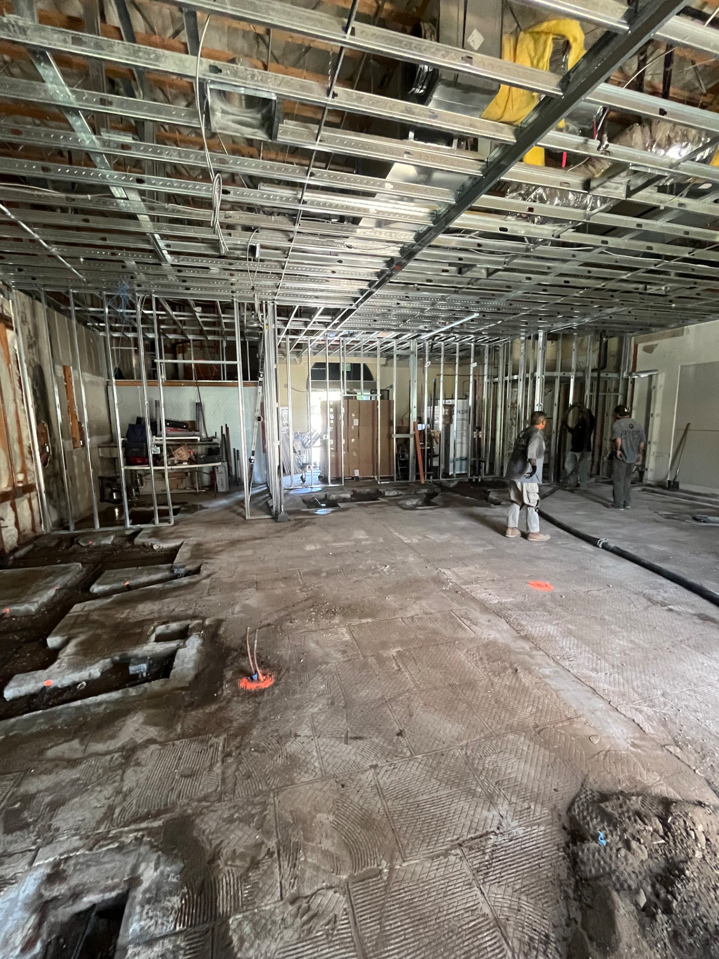 Steel framed beams spanning a wide open commercial space during construction