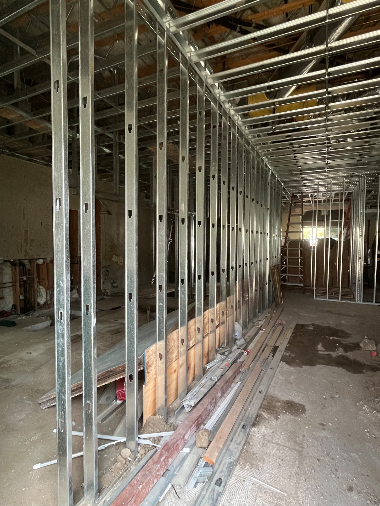 Rows of galvanized steel studs framing new interior walls in a commercial remodel